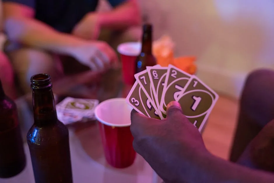 Friends enjoying a game of Uno with drinks and snacks, creating a lively party atmosphere.