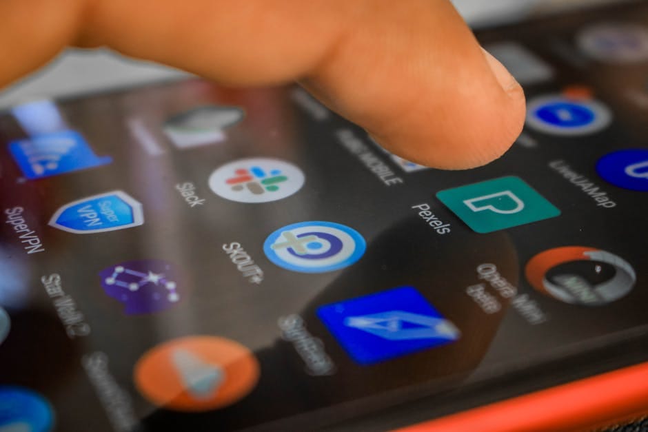 A hand interacting with a smartphone, focusing on touch screen technology and app usage.
