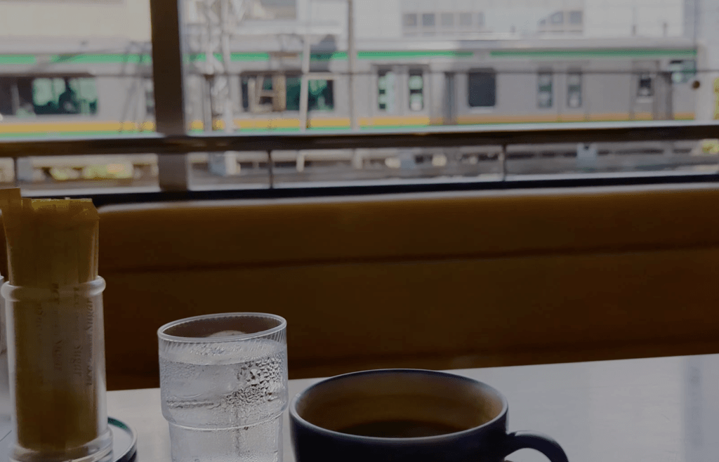 having umi blend coffee while watching the tokaido line in coffee shop umi, fujisawa